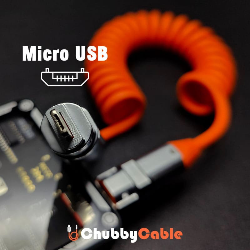 Close-up of Micro-USB connector on an orange coiled charging cable.