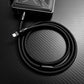 Lightning cable coiled and connected to a portable charger