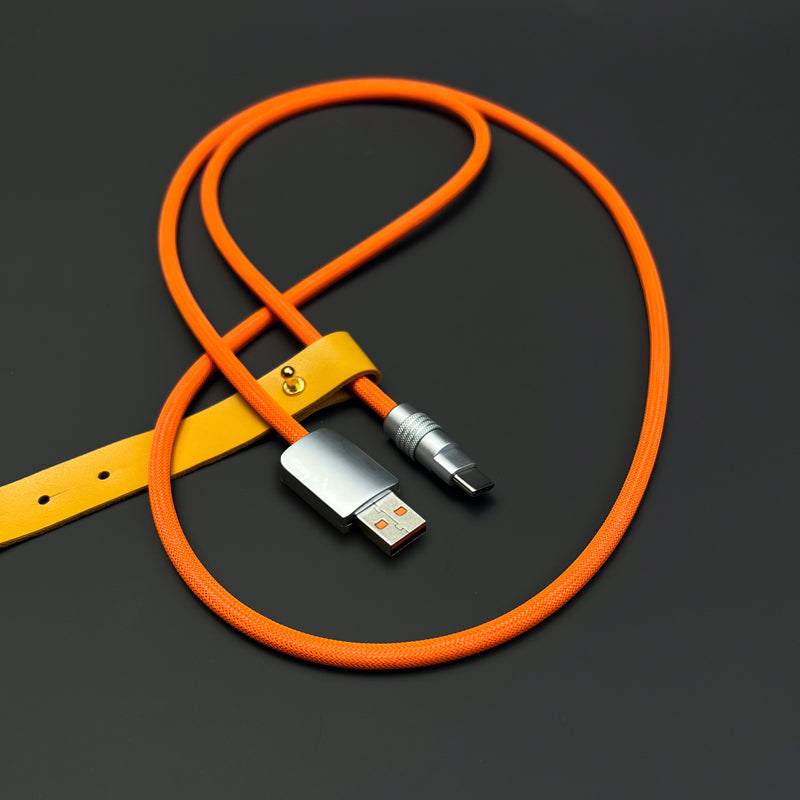 Orange braided USB charging cable with yellow leather organizer strap.