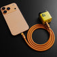 Orange Chubby Cable 240W silicone cable charging an iPhone 17 with a power adapter, demonstrating usage.