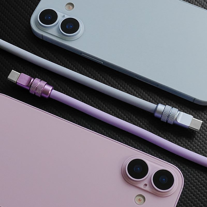 Close-up of a purple 240W silicone fast charging cable with a durable anodized connector next to an iPhone.