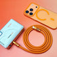 Coiled orange 240W silicone fast charging cable and matching orange accessories, top-down view.