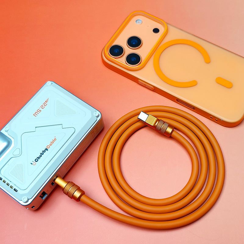 Coiled orange 240W silicone fast charging cable and matching orange accessories, top-down view.