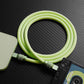 Light green coiled 240W silicone charging cable with high-quality anodized connectors.