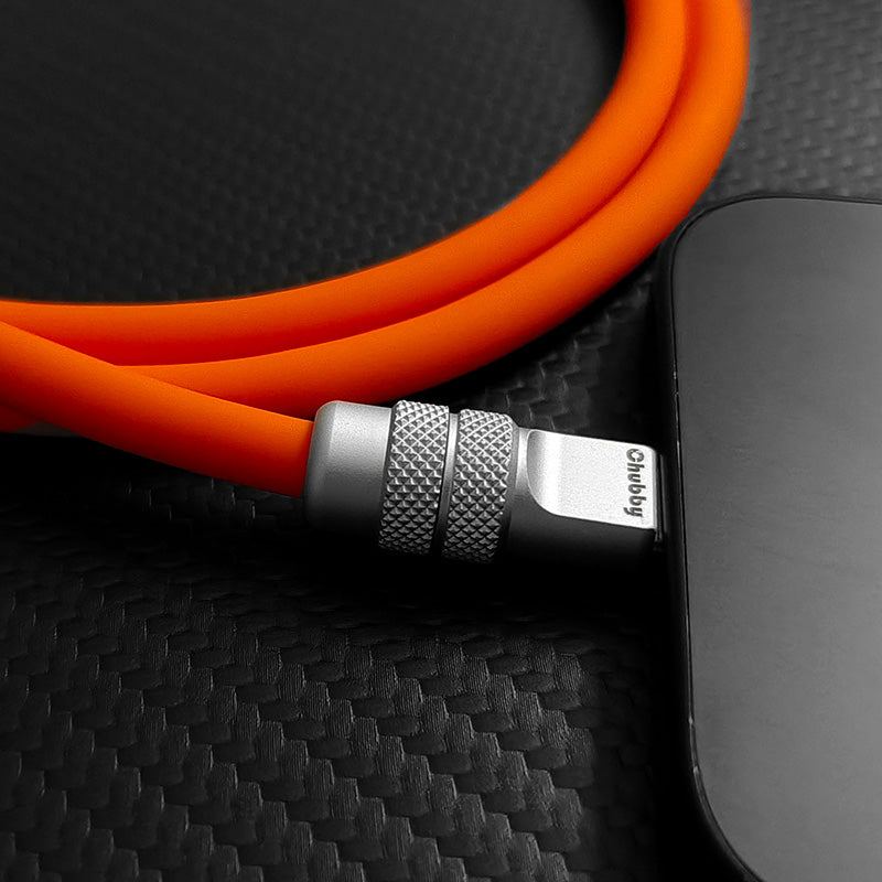 Chubby orange fast charging cable connected to phone close up