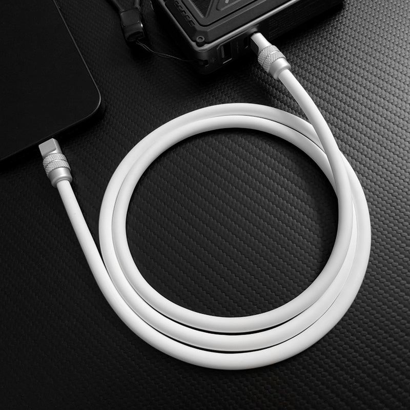 White silicone type-c fast charging cable connected to phone and power bank.