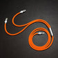 Durable orange multi-head charging cable spread on black texture.