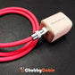 Thick red ChubbyCable plugged into a white ChubbyCharger wall adapter