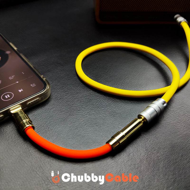 Orange Chubby Cable audio jack connected to phone playing music