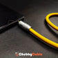Thick yellow 3.5mm headphone jack adapter plugged into smartphone