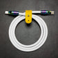 Coiled white silicone USB-C to USB-C cable featuring rainbow oil-slick finish.