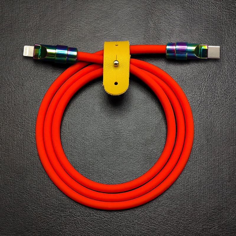 Orange silicone USB-C to Lightning data cable with rainbow zinc alloy plugs and yellow leather strap.