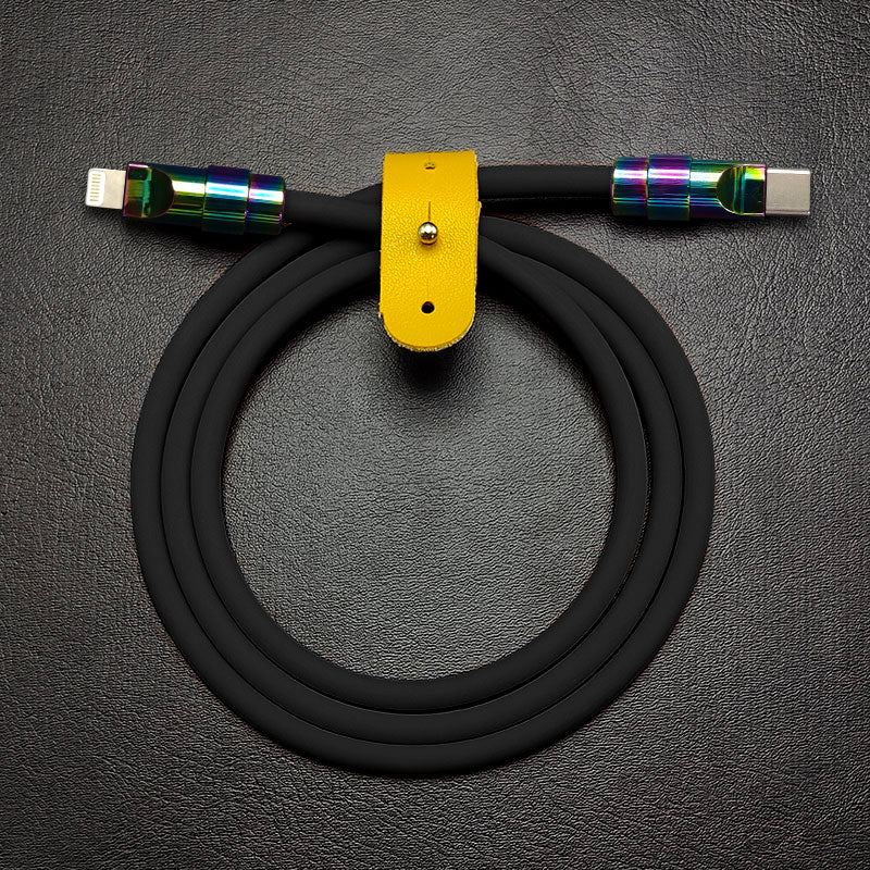 Black silicone USB-C to Lightning charging cable with rainbow metal connectors and yellow leather strap.