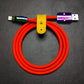 Orange silicone USB to Lightning cable featuring colorful rainbow metal housing.