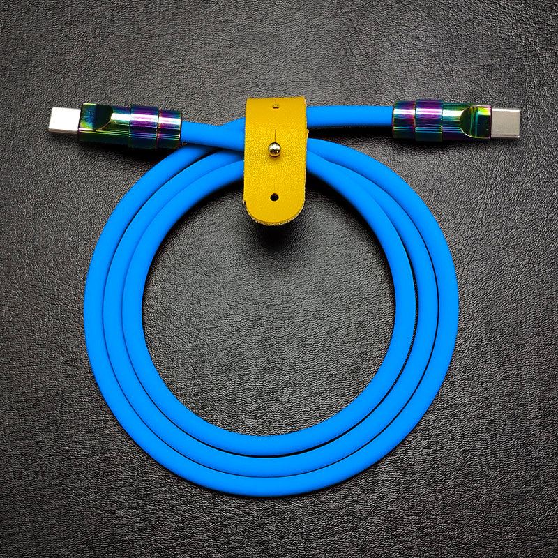 Vibrant blue silicone USB-C to USB-C charging cable with oil-slick metal finish.
