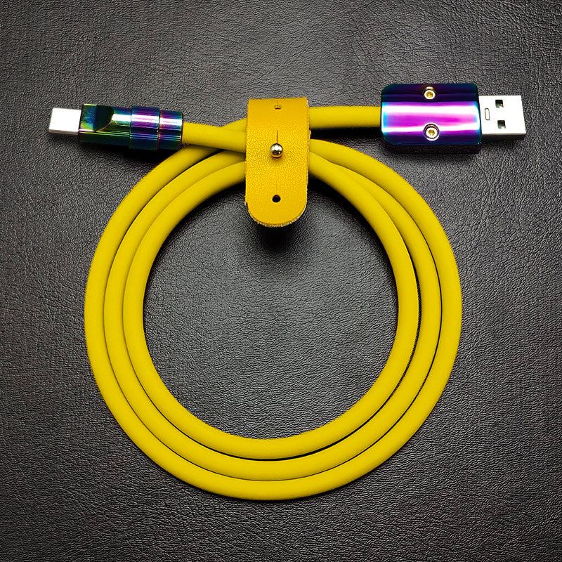 Yellow silicone USB to USB-C charging cable with rainbow metal housing and leather organizer strap.