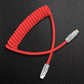 Red coiled USB-C to Lightning cable with premium metal connectors.