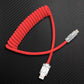 Red coiled lightning to USB cable on black background