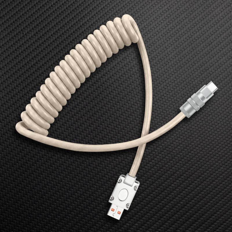 Beige coiled USB to Type-C cable on carbon fiber background