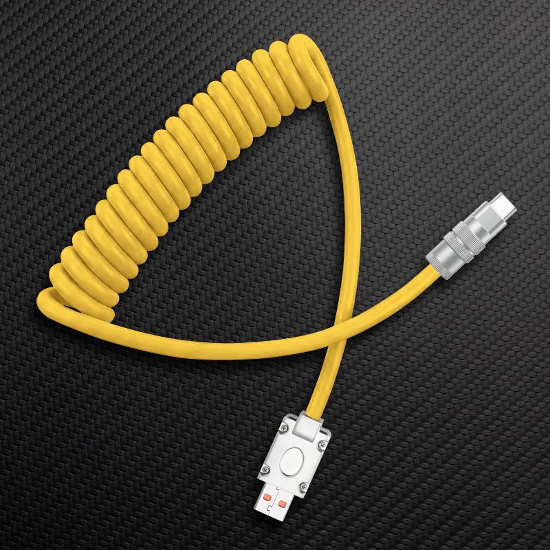 Yellow coiled USB to Type-C cable on carbon fiber background