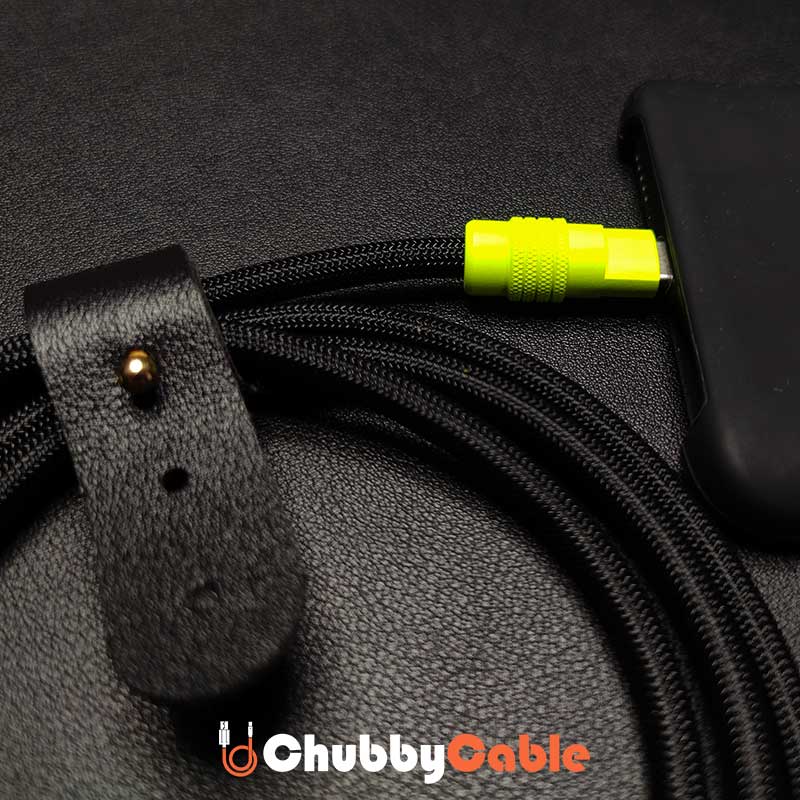 Close up of black braided Chubby Cable with yellow connector charging a smartphone