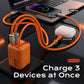 65W GaN charger simultaneously powering a laptop, phone, and earbuds.