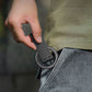 Person holding a compact folded magnetic tripod