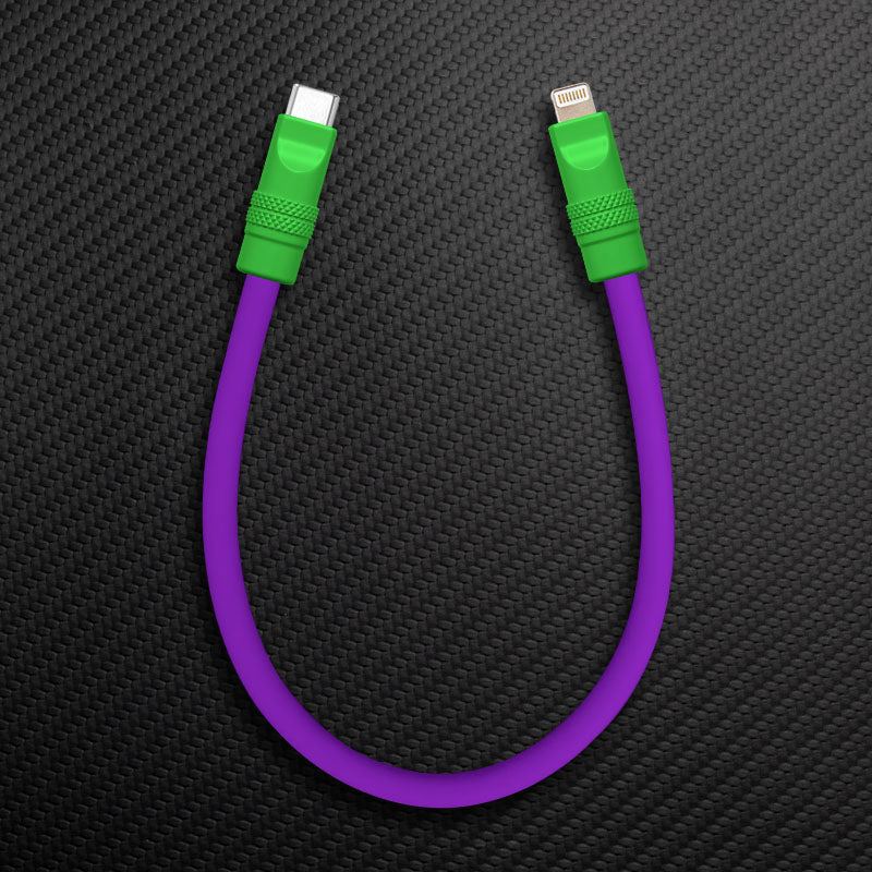 Purple and green USB-C to Lightning cable on carbon texture