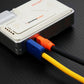 Close-up of multi-colored charging cables plugged into a power bank.