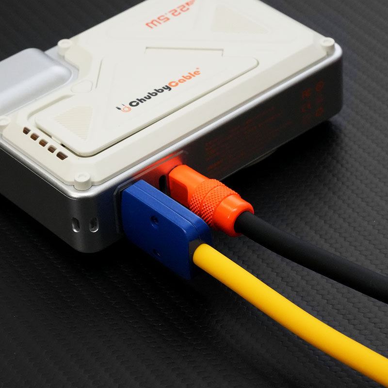 Close-up of multi-colored charging cables plugged into a power bank.