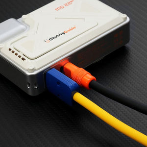 Close-up of multi-colored charging cables plugged into a power bank.