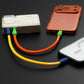 Two thick colorful short cables charging two smartphones simultaneously.