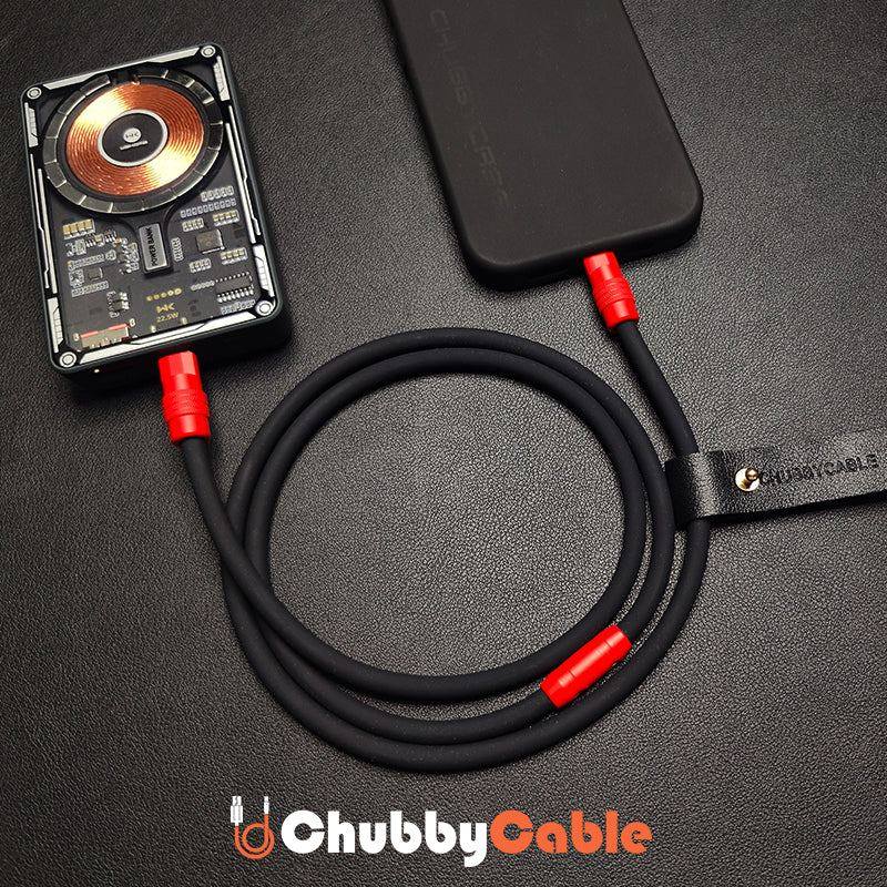 Black heavy-duty USB-C cable connected to phone and power bank