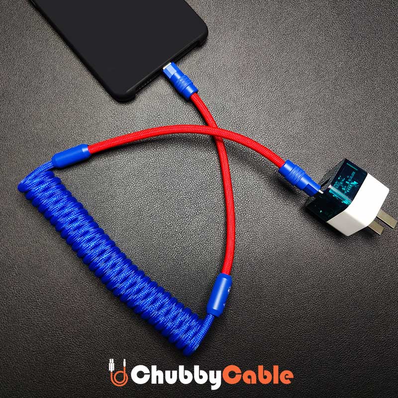 ChubbyCable red and blue coiled fast charging cable connected to a smartphone and power adapter.