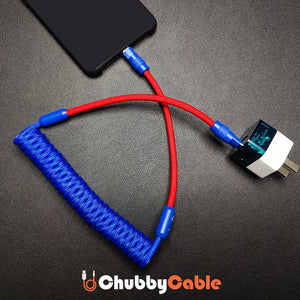 ChubbyCable red and blue coiled fast charging cable connected to a smartphone and power adapter.