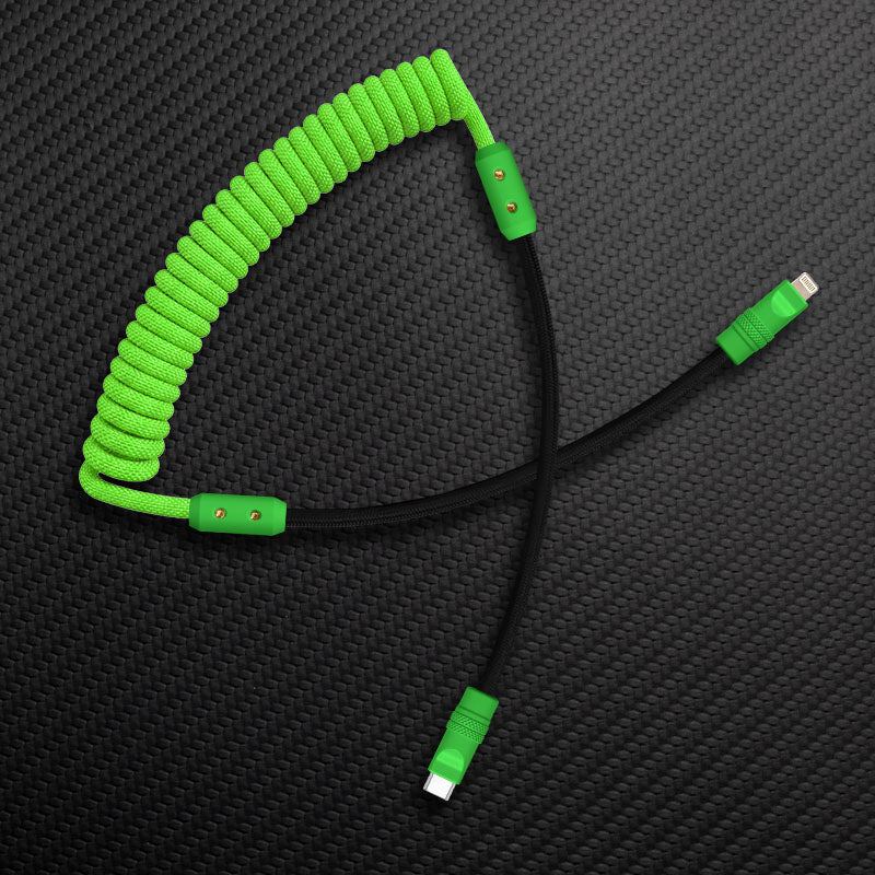Green coiled Lightning cable with black straight wire on carbon texture