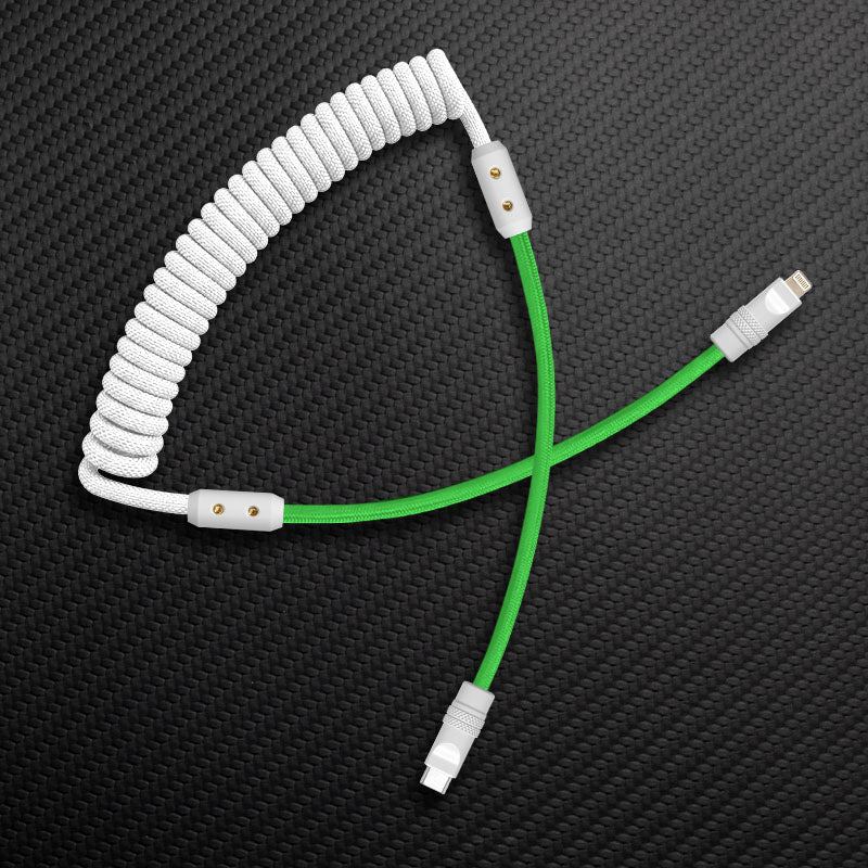Coiled mechanical keyboard cable in white and green.