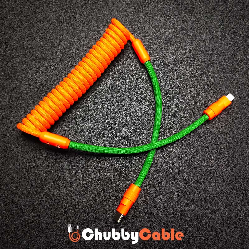 ChubbyCable orange and green coiled Type-C to Type-C fast charging braided cable.
