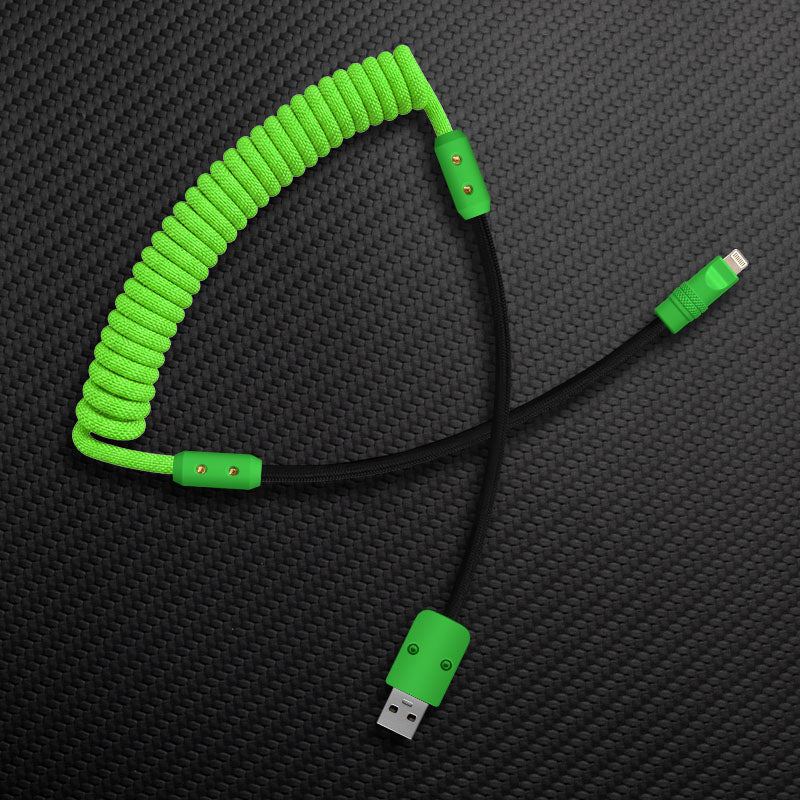 Neon green and black coiled heavy-duty charging cable on textured background.