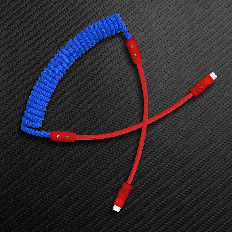 Blue coiled USB-C cable with all-red wire and connectors on carbon