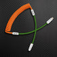 Orange and green coiled USB-A to Lightning charging cable
