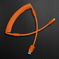 Orange coiled aviator cable USB to Lightning