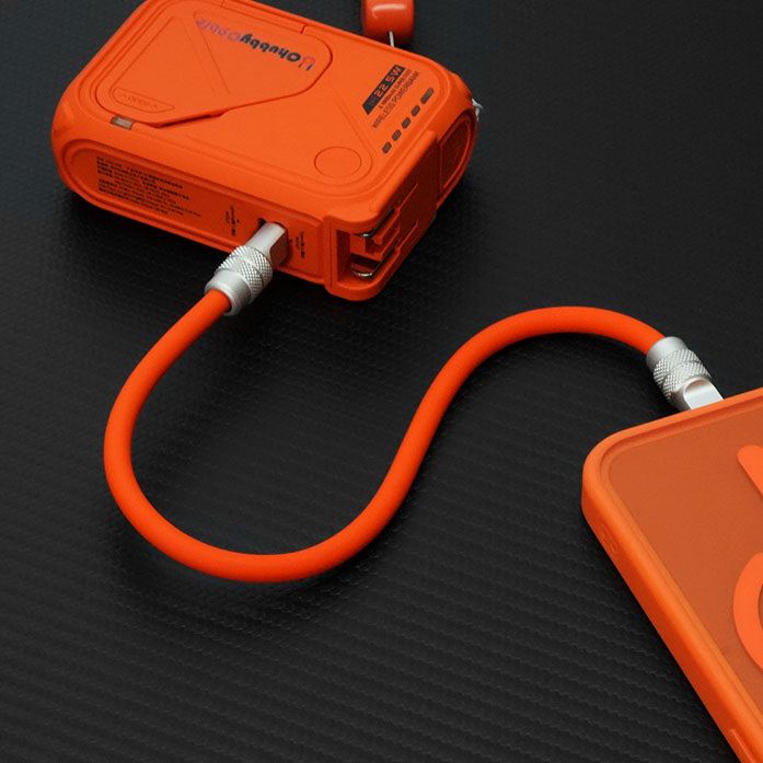 Orange short cable charging smartphone from portable power bank