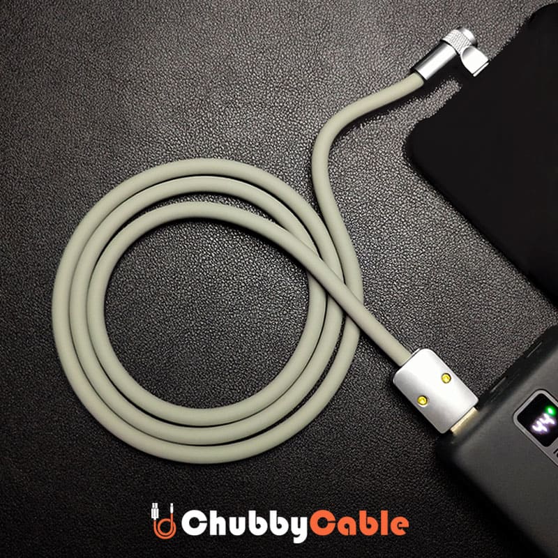 Coiled grey silicone right-angle charging cable connected to power bank