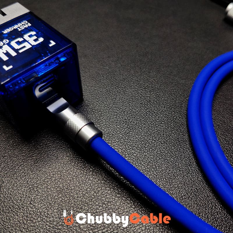 Blue silicone fast charging cable plugged into a transparent 35W Gan charger