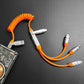 Versatile orange coiled charging cable with multiple output heads connected to power bank.