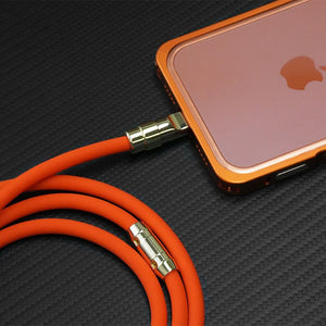 Orange silicone fast charging cable plugged into an iPhone.