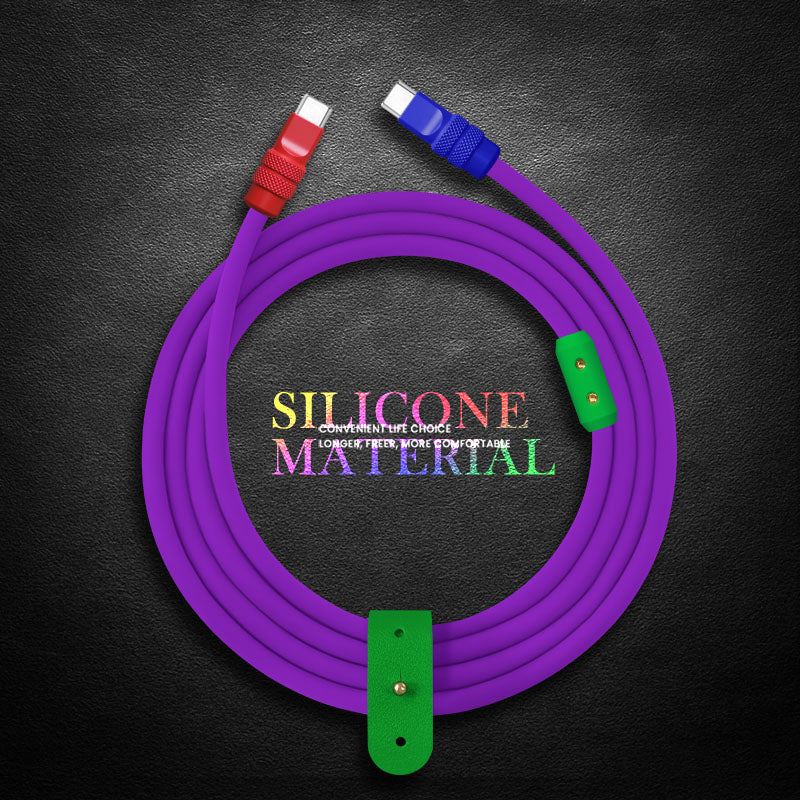 Coiled purple silicone charging cable with green organizer strap on textured background.