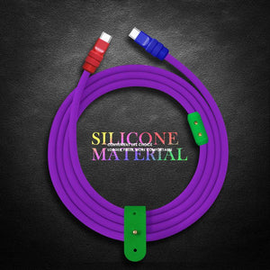 Coiled purple silicone charging cable with green organizer strap on textured background.