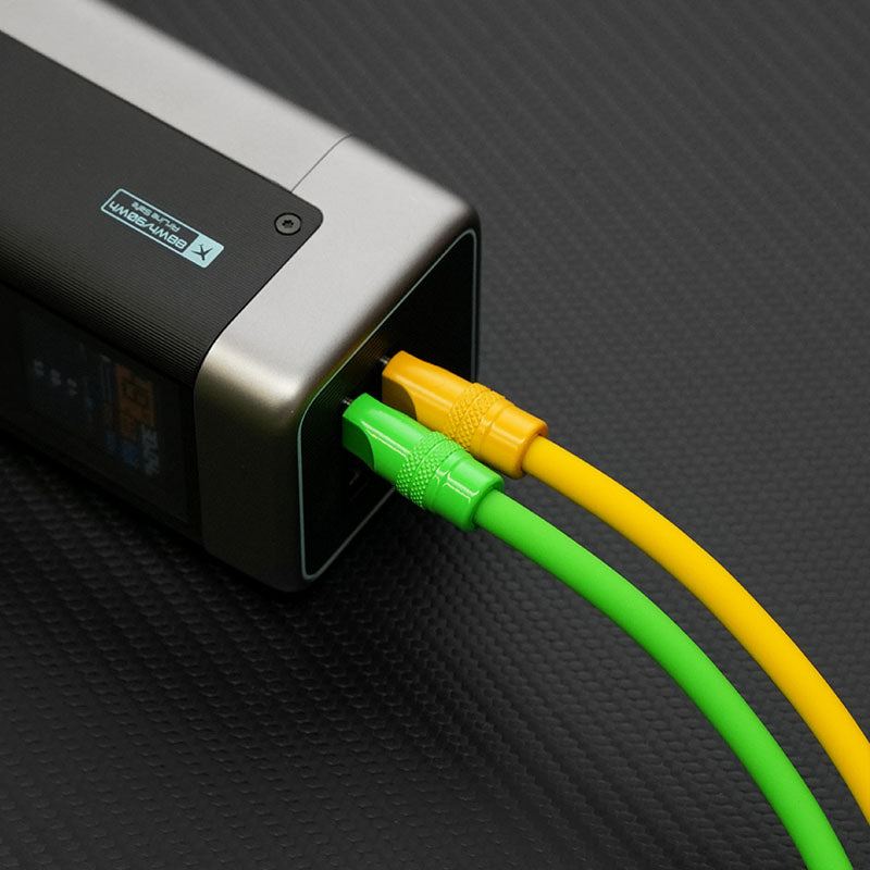 Bright green and yellow thick Type-C cables plugged into a portable power station.